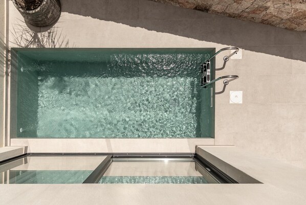 A rectangular pool with clear water, surrounded by a tiled deck. - Seven Rocks Chalkidiki (Kassandra)