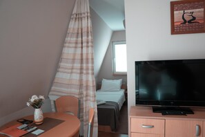 A hotel room with a bed, a television, a desk with a chair, and a window. - Hotel Topcider (Belgrade)