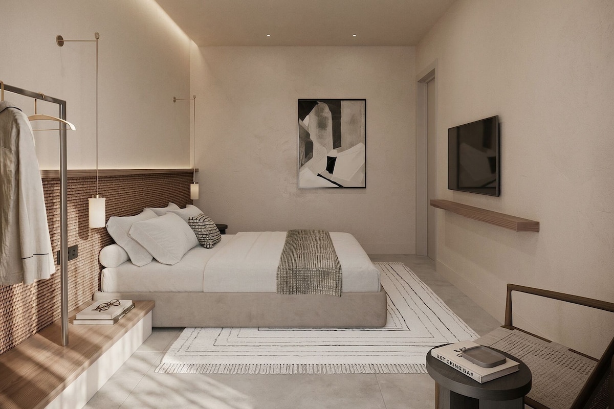 Un dormitorio moderno con cama, mesita de noche, televisor, obra de arte y espejo.