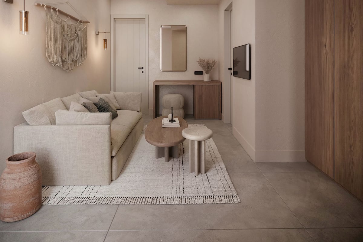 Ein modernes Wohnzimmer mit einer Couch, einem Couchtisch und einem kleinen Teppich.