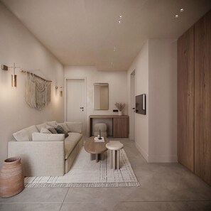 A modern living room with a sofa, coffee table, and a small rug. - Breaq Santorini Hotel (Santorini)