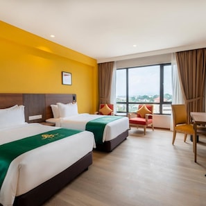 A hotel room with two beds, a view of the city, and a dining area. - Arena Premier Hotel (Seremban)