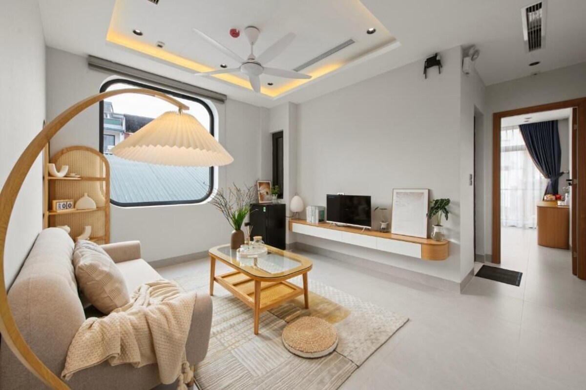 A modern living room with a sofa, coffee table, and a large window.