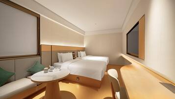 A modern hotel room with a large bed, a seating area with a table, and a television mounted on the wall.