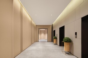 A modern hallway with a light-colored floor, beige walls, and recessed ceiling lights. - JI Hotel Xian Bell Tower North Street Metro Stati (Xi'an)