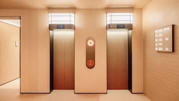 An elevator with a digital display, a control panel, and a wall-mounted information board.