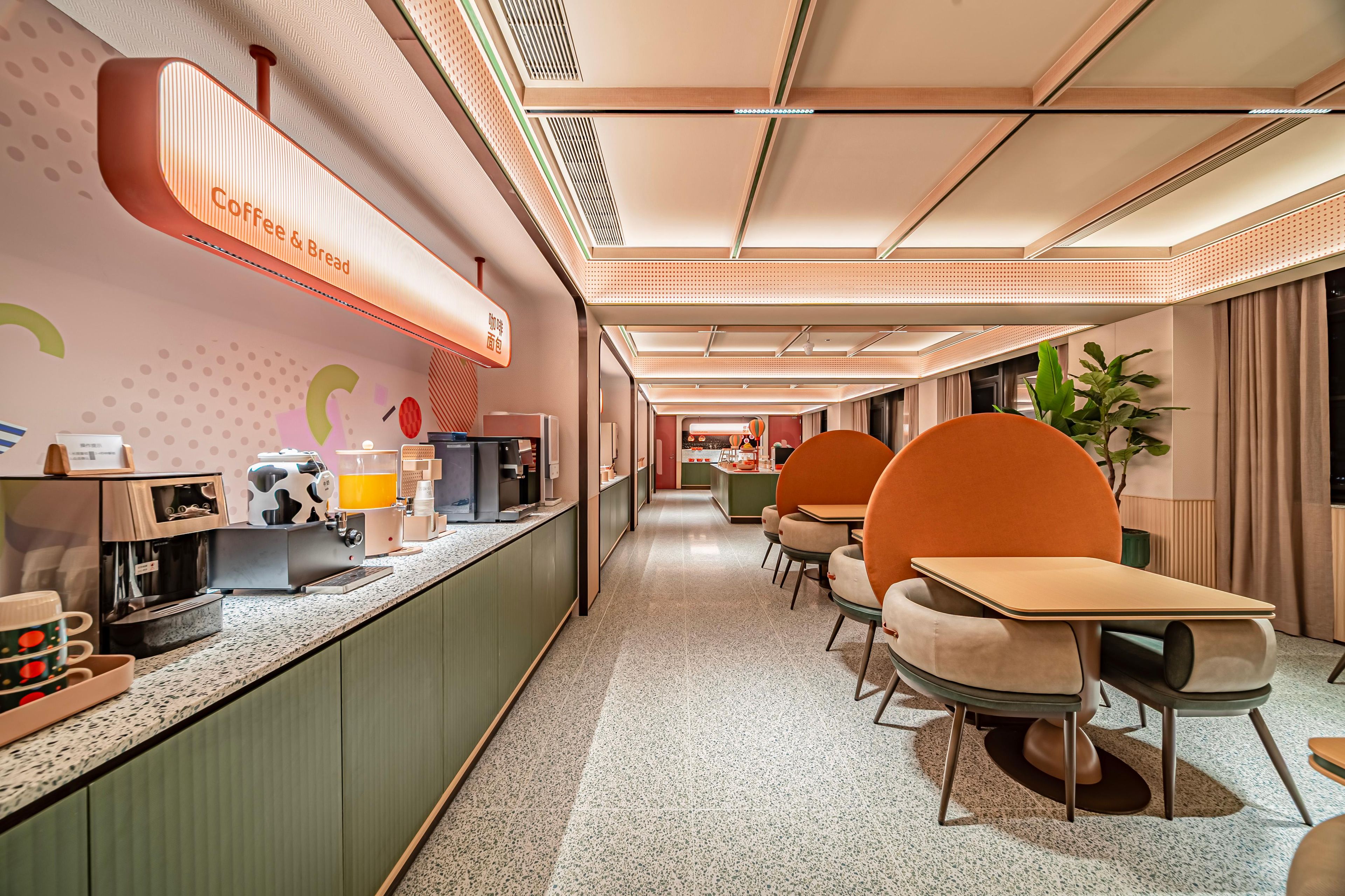 A modern cafe with a long counter, seating area, and a visible coffee machine.