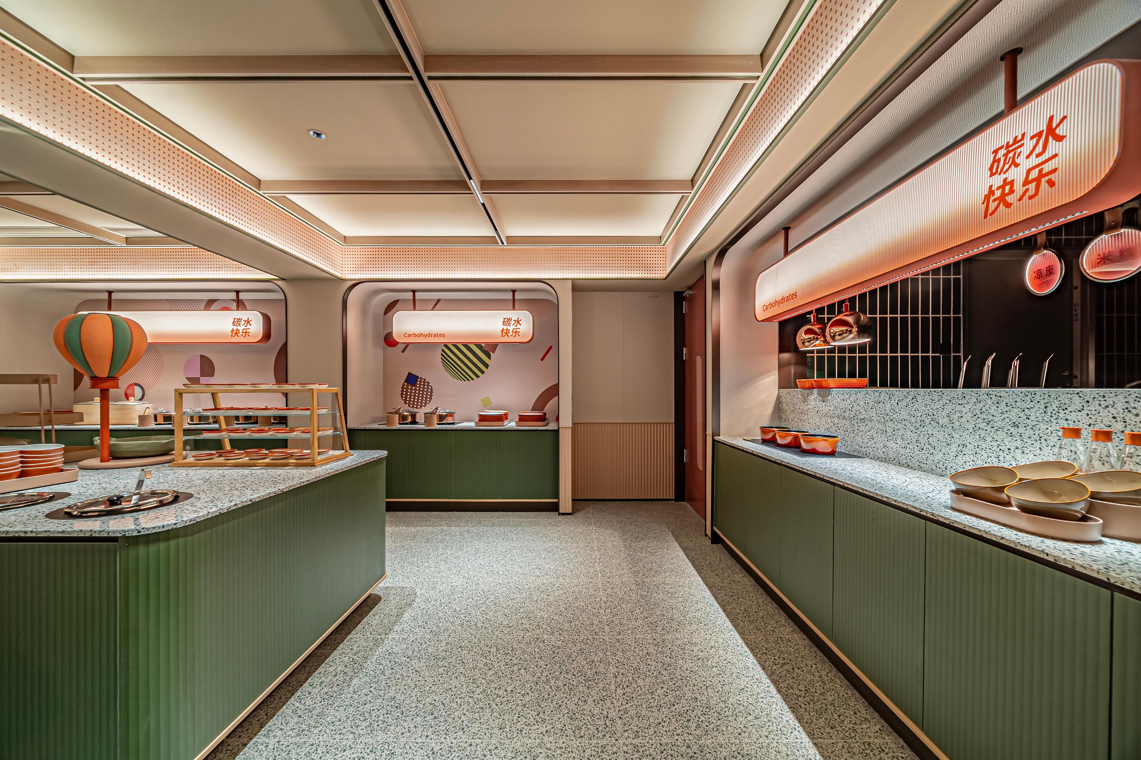 A modern kitchen with a central island, overhead lighting, and a counter displaying kitchen utensils.