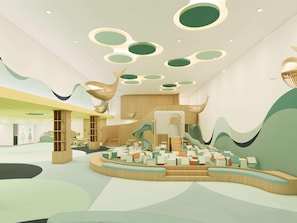 A modern interior with a central seating area, a staircase, and abstract wall art.