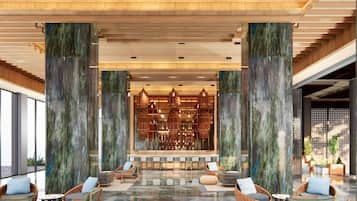 A spacious lobby with a central bar area, seating arrangements, and large columns.