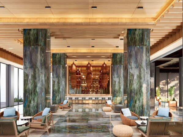 A spacious lobby with a central bar area, seating arrangements, and large columns. - Mövenpick Resort Carita (Serang)