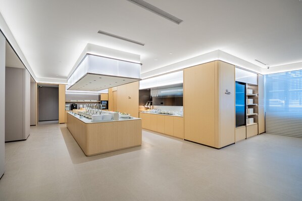 A modern kitchen with a central island, built-in appliances, and a view of the city. - JI Hotel (Xi'an)