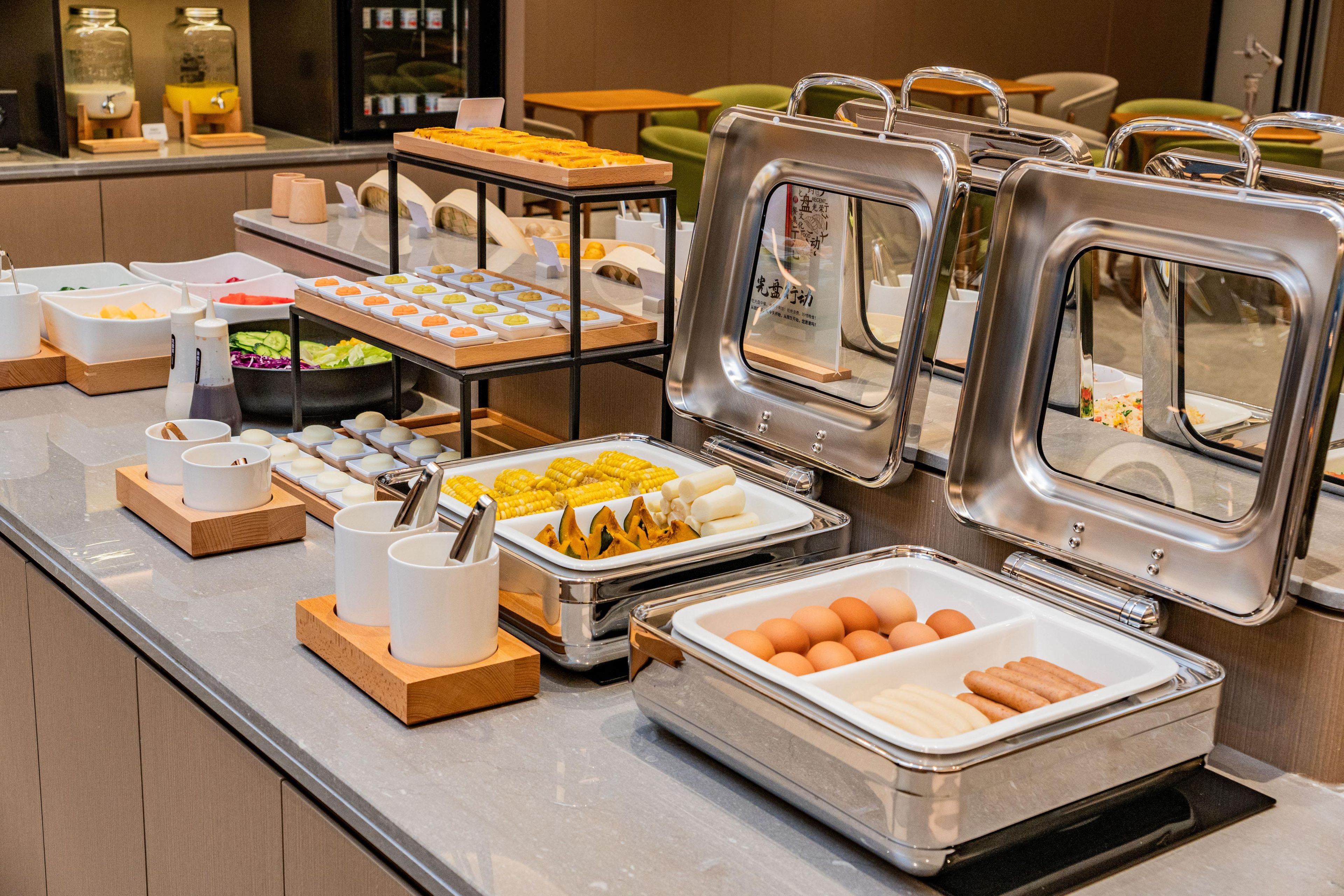 A buffet with various food items and condiments.
