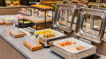 A buffet with various food items and condiments.