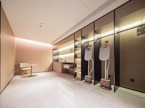 A modern bathroom with a vanity, a mirror, and a shower area.