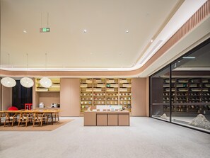 A modern interior with a central island, seating area, and shelving units. - JI Hotel Xian National Supercomputing Center East (Xi'an)