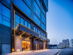A modern hotel with a glass facade, a prominent entrance, and a well-lit exterior. - JI Hotel Xian National Supercomputing Center East (Xi'an)