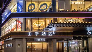 A hotel with a modern facade, large glass windows, and a prominent entrance.