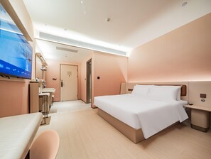 A hotel room with a bed, a desk, a chair, a television, and a door. - Hanting Hotel Xian Bell Tower Dachaishi Metro St (Xi'an)