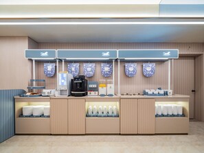 A self-service beverage station with multiple dispensers and a counter displaying cups and bottles. - Hanting Hotel Xian Bell Tower Dachaishi Metro St (Xi'an)