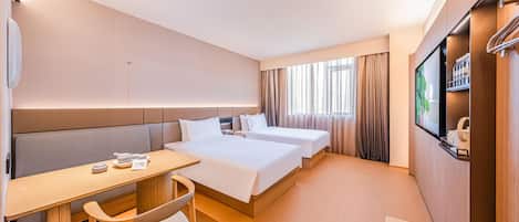 A hotel room with two beds, a desk, a chair, a TV, and a window with curtains.