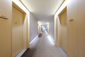 A hotel hallway with doors numbered 8512 and 8515, carpeted floors, and a straight layout. - JI Hotel (Xi'an)