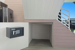 A secure entryway with a metal door, a small window, and a metal gate. - Junglo Resort And Spa (Peñas Blancas)