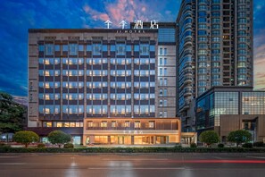 A modern hotel building with multiple floors, large windows, and a well-lit entrance. - JI Xian Bell Tower Yongning Gate Metro Stat (Xi'an)