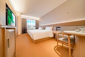 A hotel room with a bed, a desk, and a television. - JI Xian Bell Tower Yongning Gate Metro Stat (Xi'an)