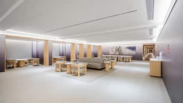 A modern interior with a sofa, coffee table, and chairs arranged in a living area.