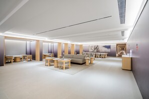 A modern interior with a sofa, coffee table, and chairs arranged in a living area. - JI Hotel (Xi'an)