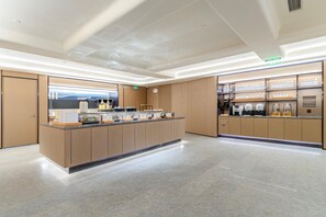 A modern kitchen with a central island, equipped with various appliances and utensils. - JI Hotel (Xi'an)