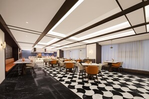 A modern restaurant with a black and white checkered floor, multiple dining tables, and a bar area in the background. - Meilun Hotel (Xi'an)