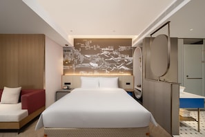 A modern hotel room with a large bed, a seating area with a red chair, a wall-mounted TV, and a bathroom with a mirror and sink. - Meilun Hotel (Xi'an)
