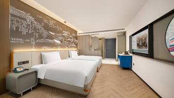 A hotel room with a large bed, bedside tables, a wall-mounted TV, and a modern design.