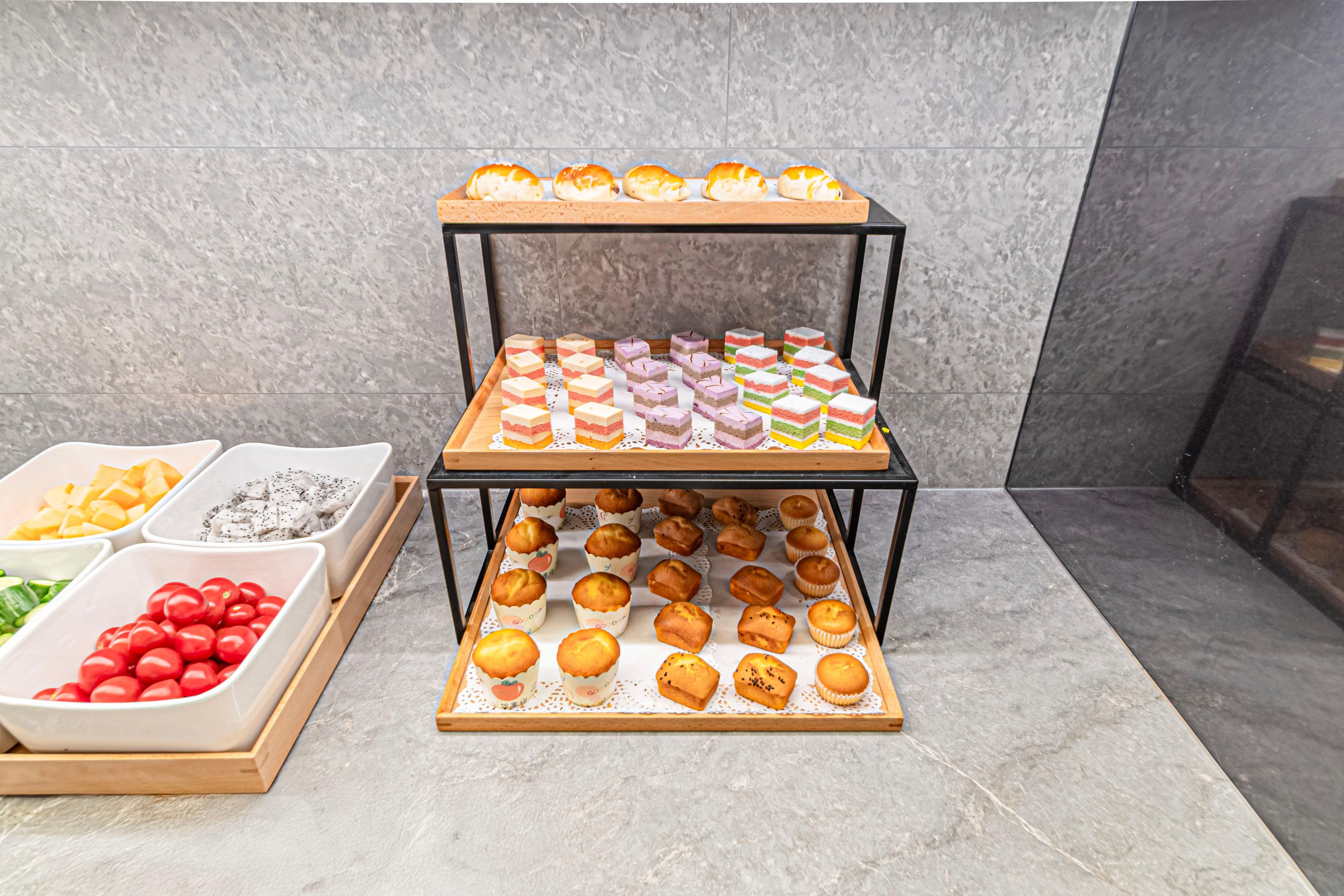A display of various baked goods on a tiered stand.