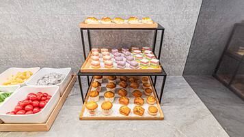 A display of various baked goods on a tiered stand.