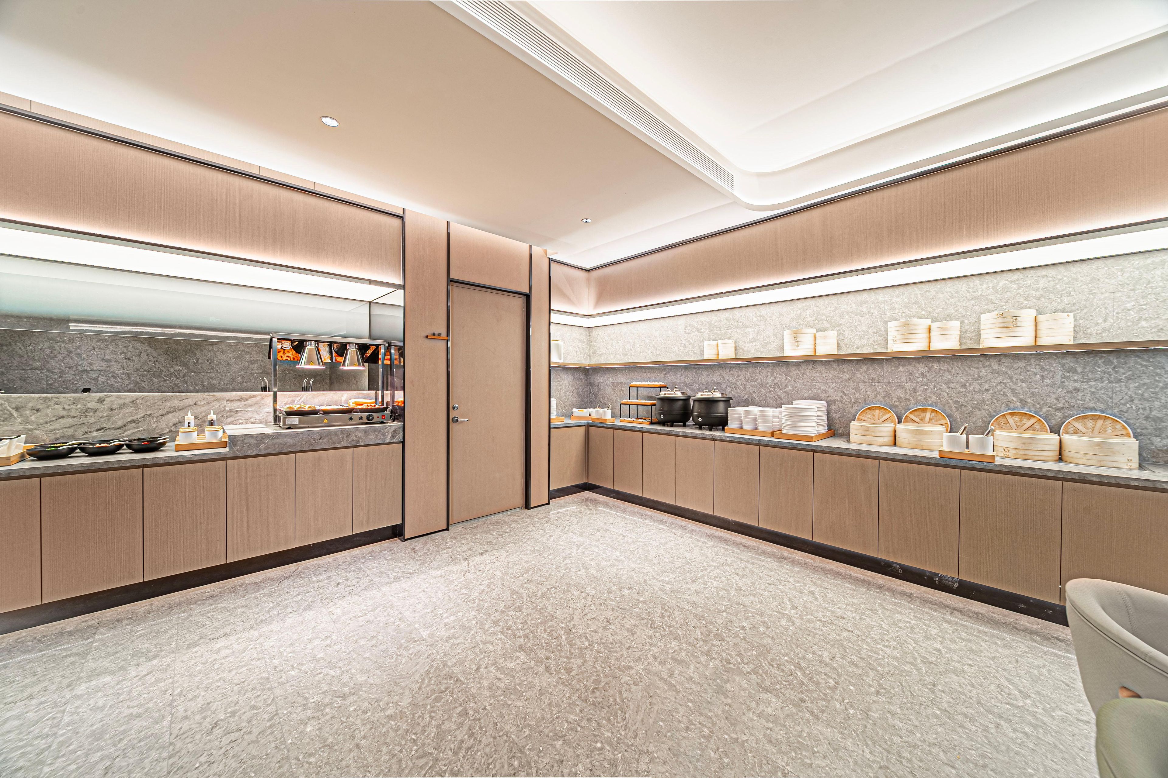 A modern kitchen with a marble countertop, stainless steel appliances, and wooden cabinets.