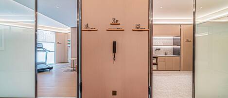 A hotel entrance with a wooden door, a gym, a restaurant, and a laundry area.
