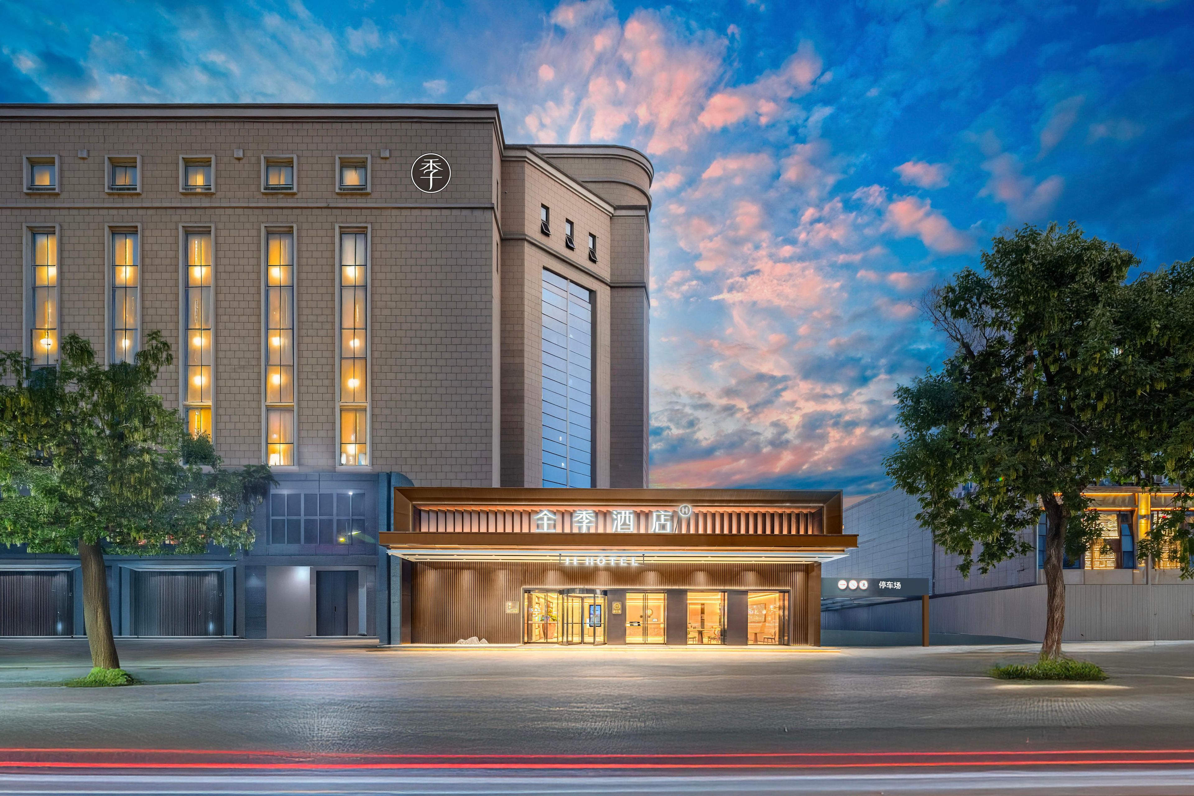 A hotel with a modern facade, large windows, and a prominent entrance.