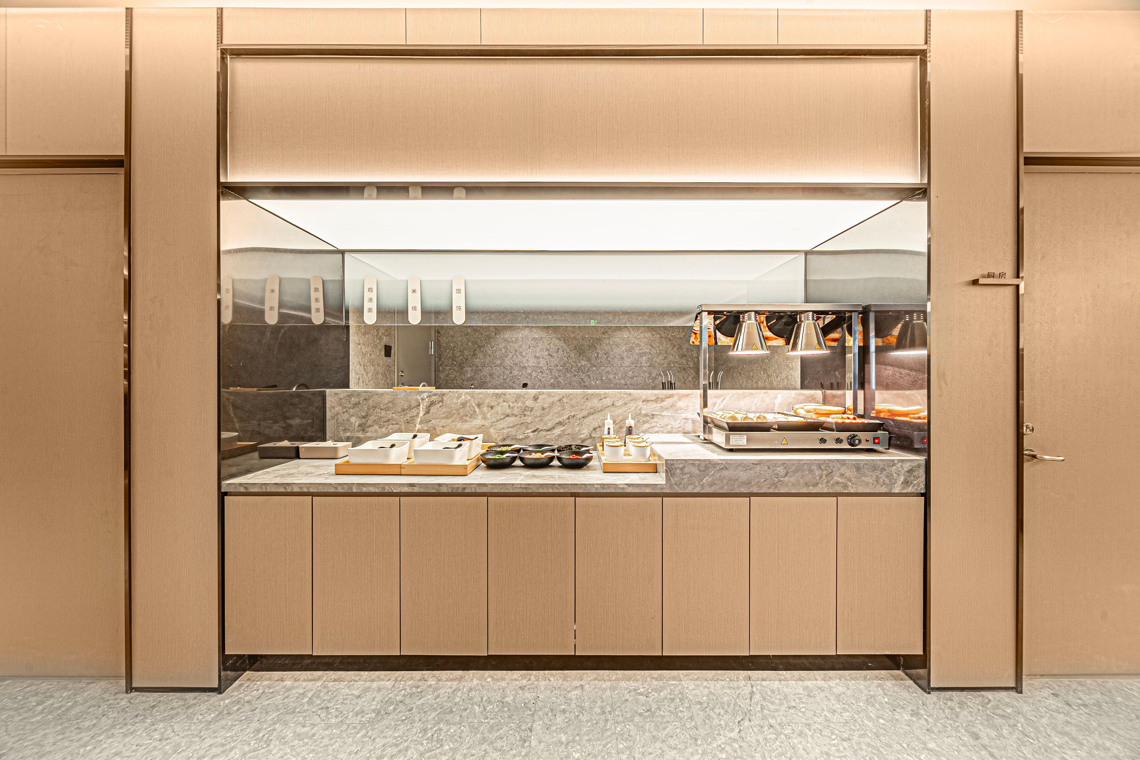 A compact kitchen with a built-in stove, a microwave, and a small sink.