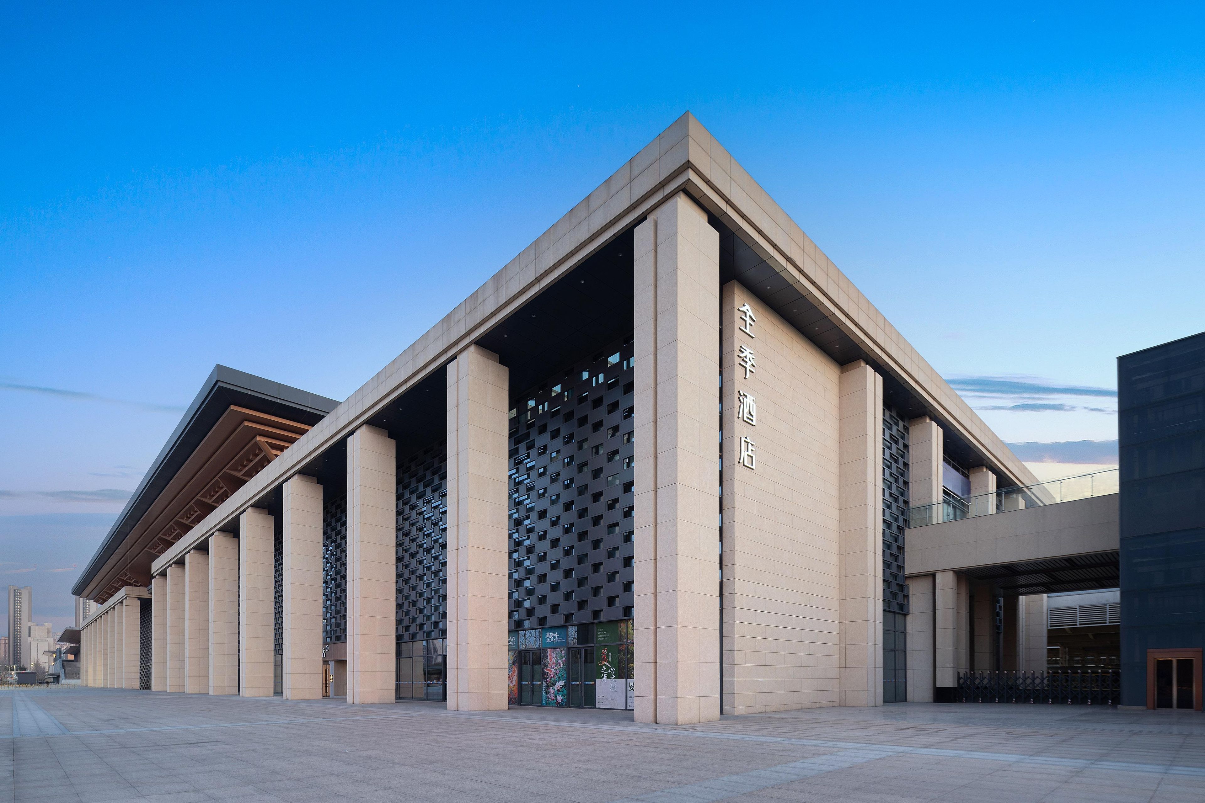 A modern building with a prominent entrance and a series of columns.