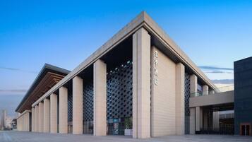 A modern building with a prominent entrance and a series of columns.