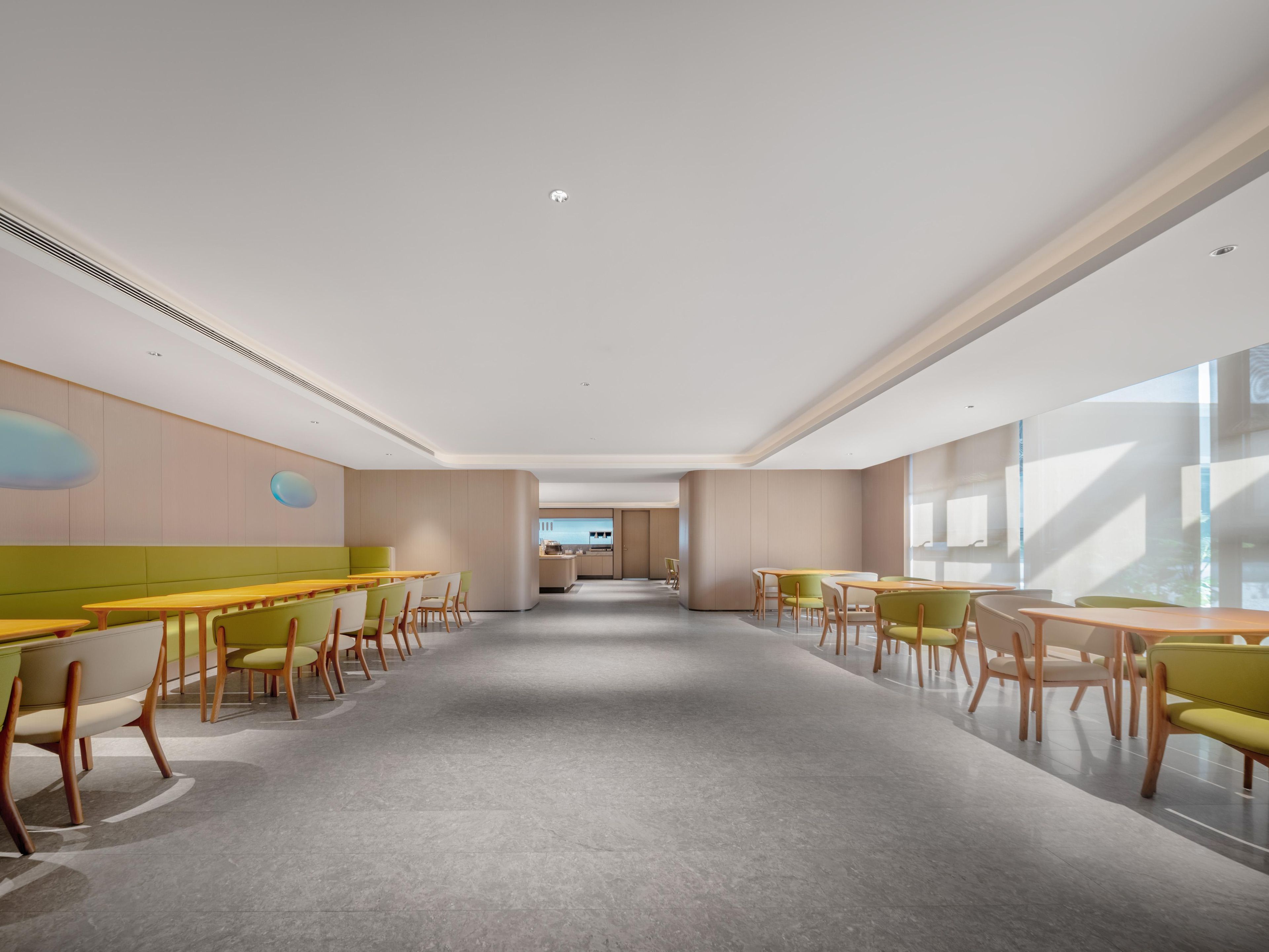 A spacious, modern dining area with high ceilings and large windows.