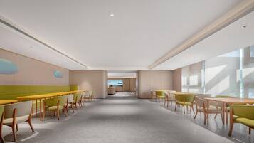 A spacious, modern dining area with high ceilings and large windows.