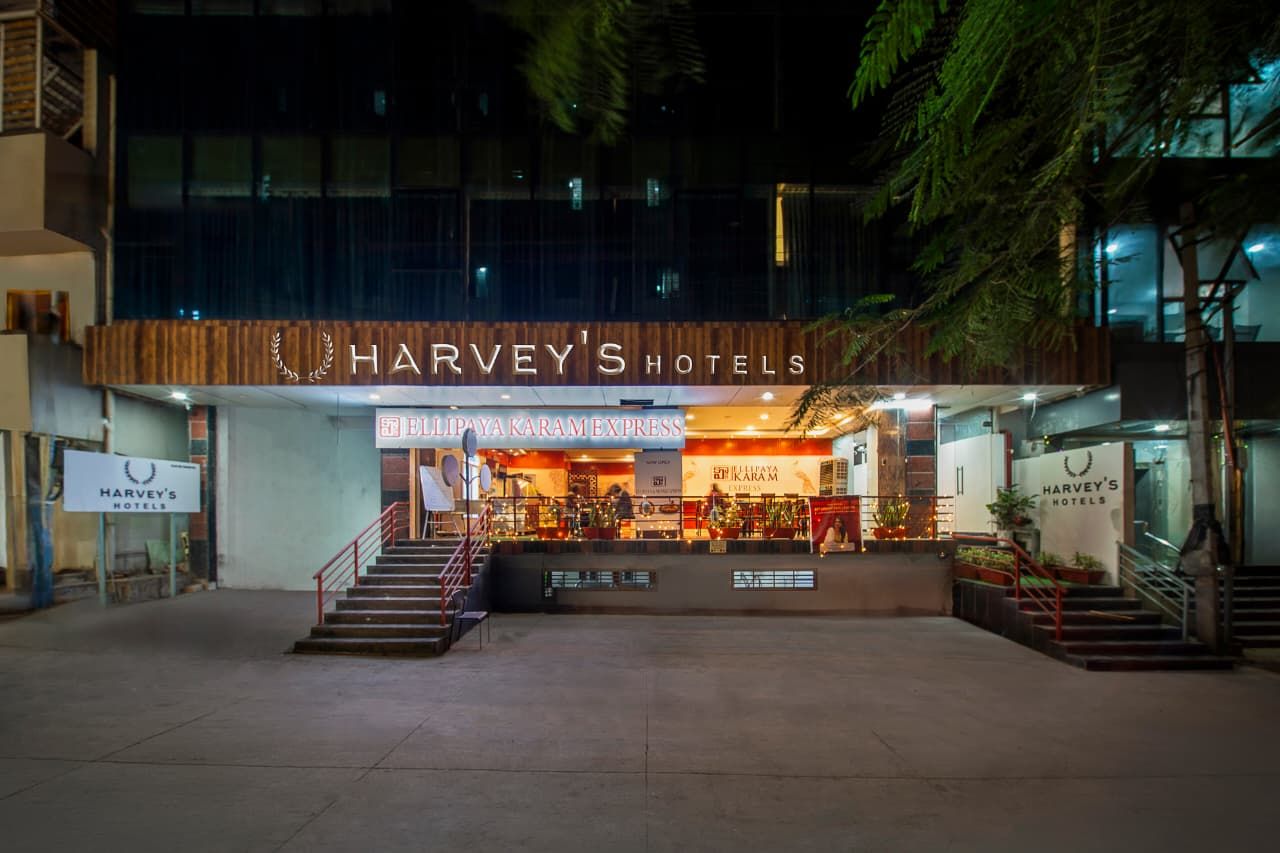 A hotel entrance with a sign reading 'Harvey's Hotels' and a visible entrance.