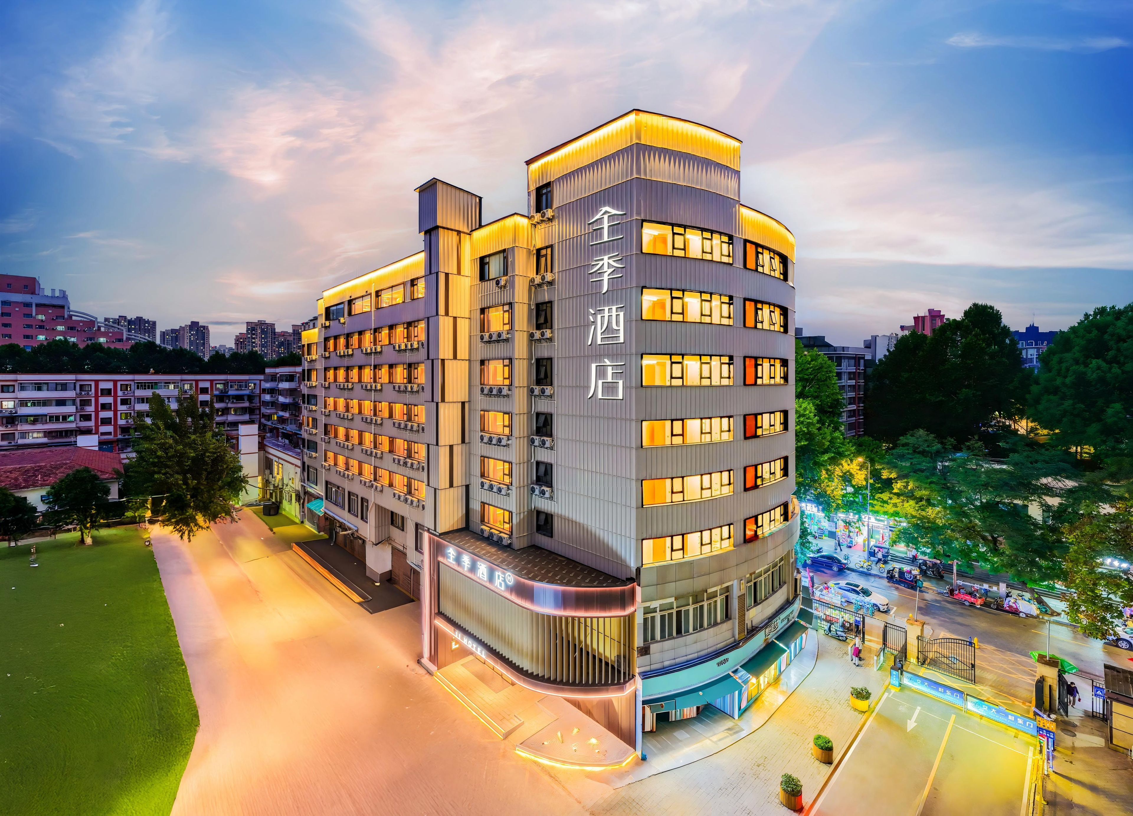A multi-story hotel with a modern design, featuring balconies and a prominent entrance.