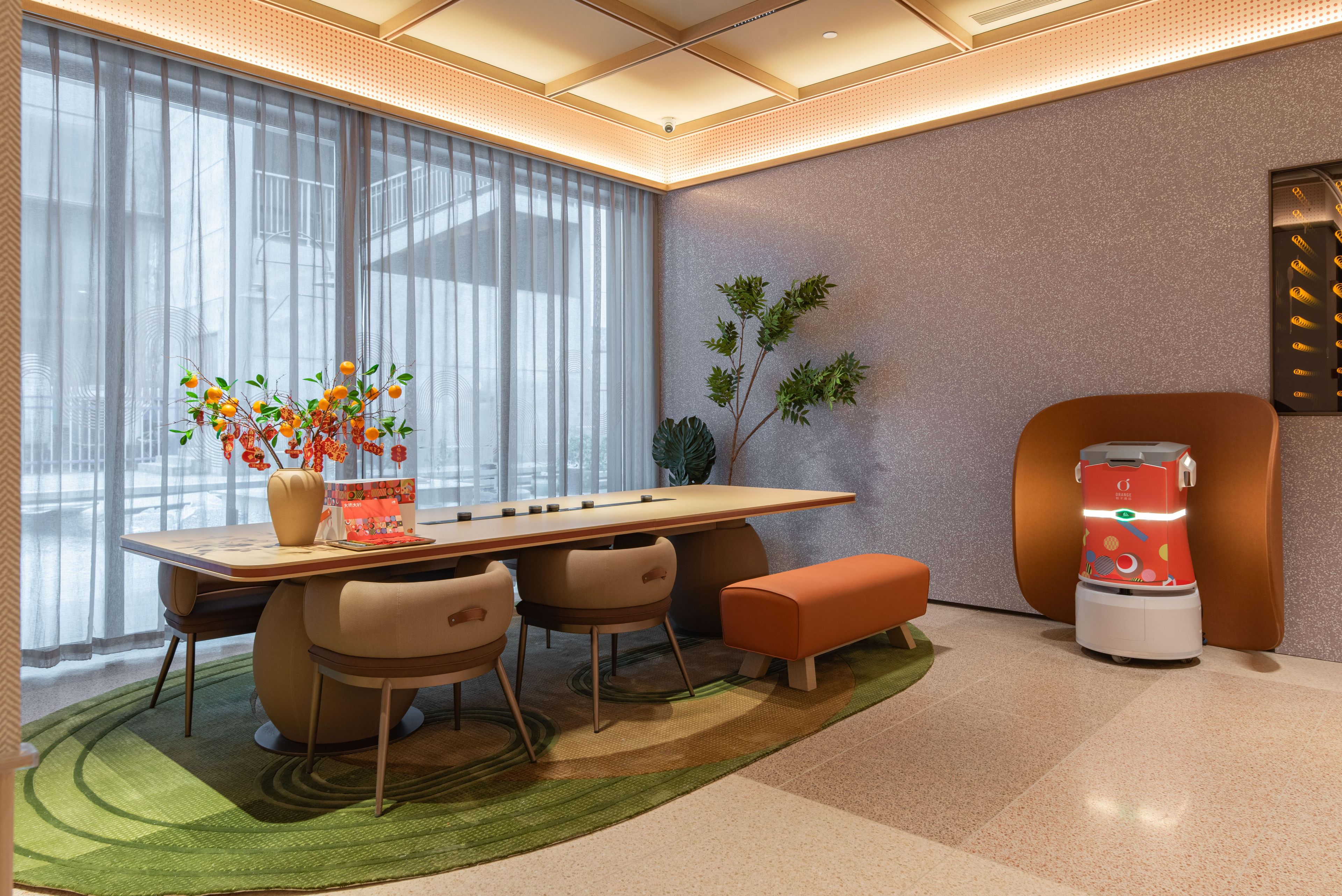 A modern room with a dining table, chairs, a bench, a coffee machine, and a plant.