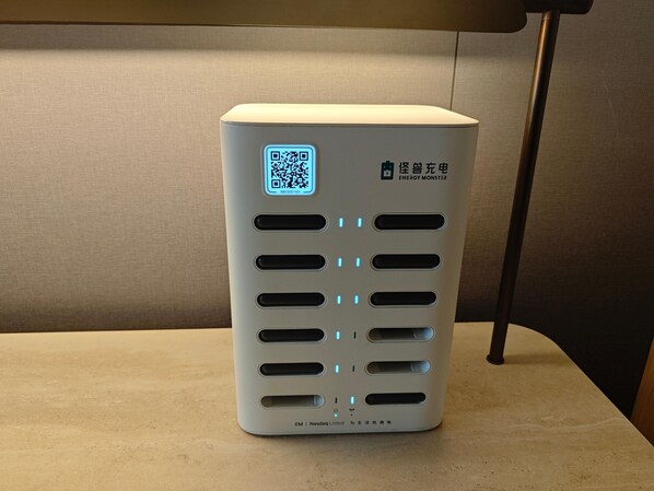 A white, rectangular device with a QR code and the label 'ENERGY MONSTER' on its side.