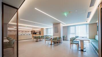 A modern interior with a central dining area, kitchen, and seating space.